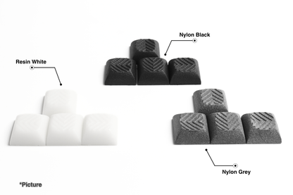 DSA Arrow Keycaps Shown in Resin White, Nylon Black, and Nylon Grey