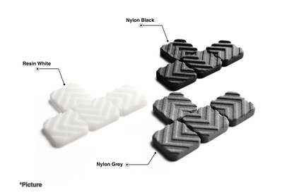 FMX Arrow Keycap Set Shown in Resin White, Nylon Black, and Nylon Grey