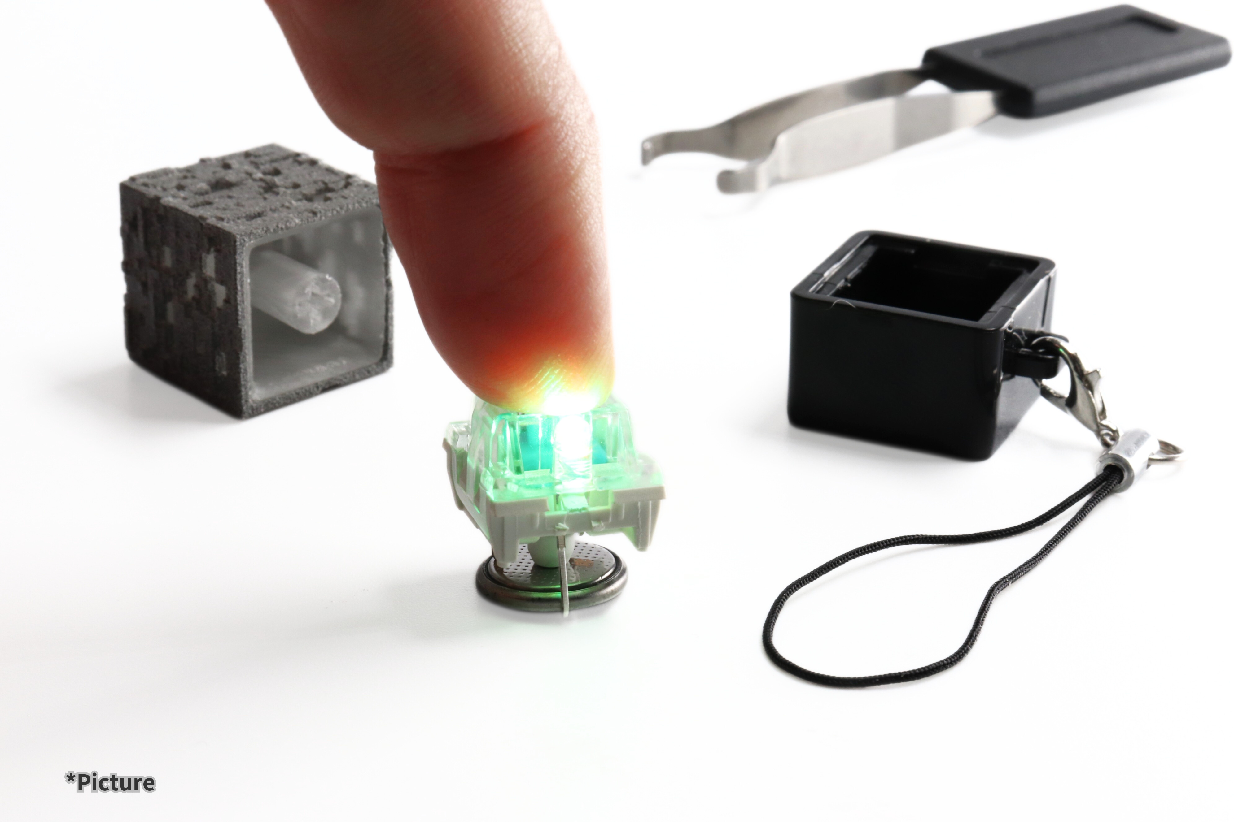 Finger pressing switch tester beside minecraft ore keycap